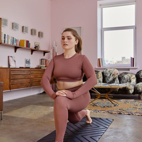 Calendar with a checkmark and a yoga mat next to it symbolizing a daily routine.