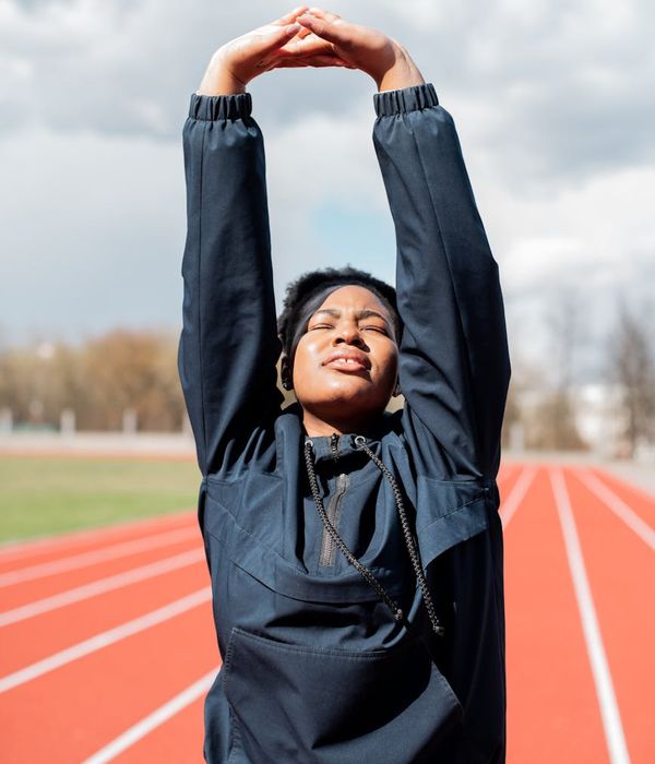 Person feeling energized and stretching towards the sky.